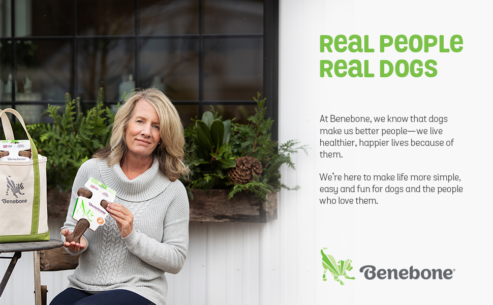 A woman holding a Benebone Wishbone dog bone