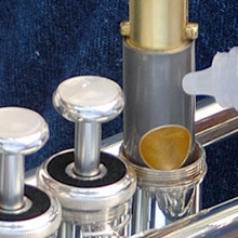 closeup of oil being applied to a trumpet piston