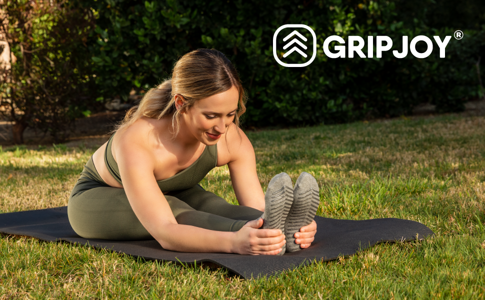 Woman wearing Gripjoy grip socks doing a stretch