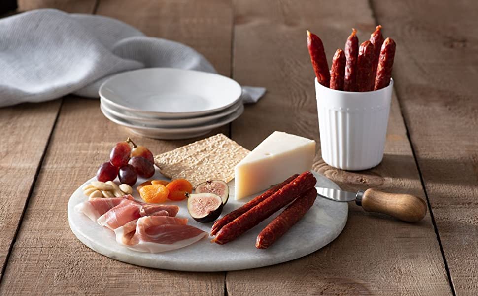 Platter with fruit, Salamini dried meat and cheese on a table with serving plates