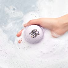 Purple Lavender Bath Bomb being dropped into soap water.